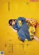 A woman laying on a yellow surface with a yellow background.