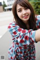 A woman in a blue and red dress posing for a picture.