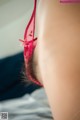 A close up of a woman wearing a red bra.