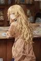 A girl with long blonde hair sitting at a table.