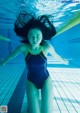 A woman in a blue and yellow swimsuit in a swimming pool.